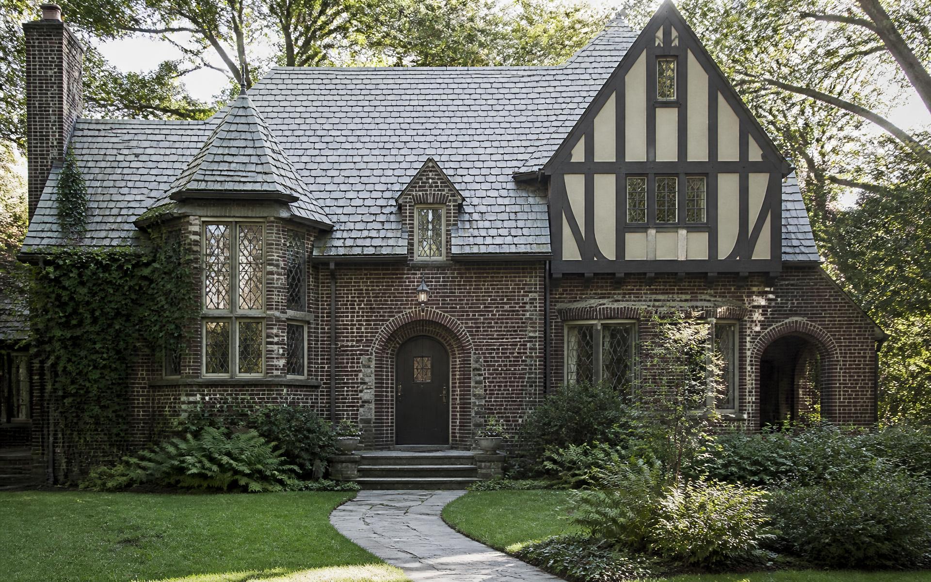 1920s Tudor Revival house with slate roof, leaded glass bay window and half-timbered gable in Myers Park